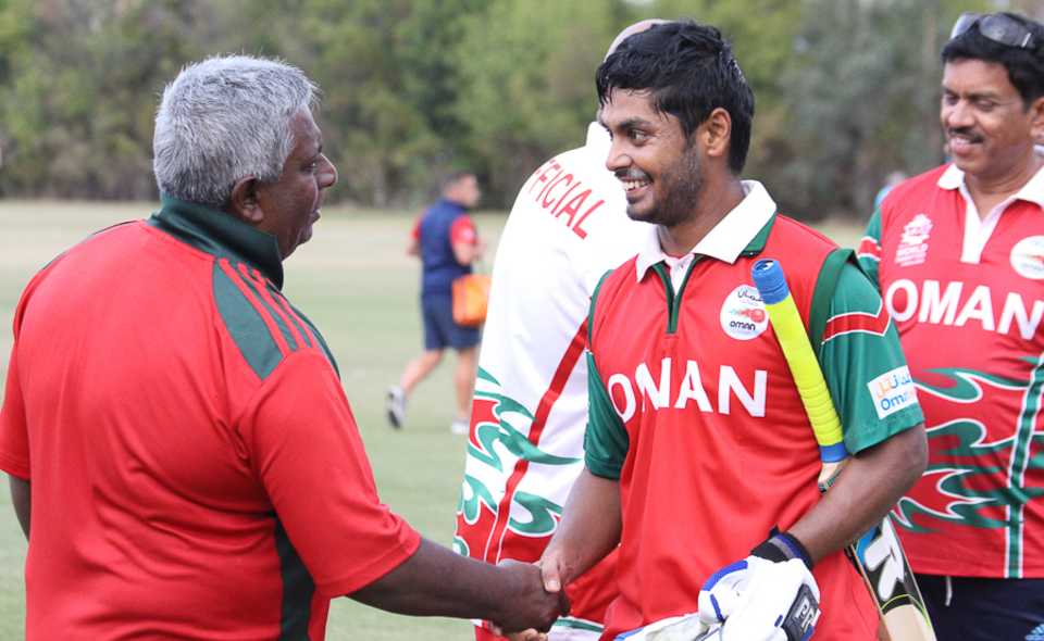 Oman coach Duleep Mendis congratulates Swapnil Khadye on his unbeaten half-century
