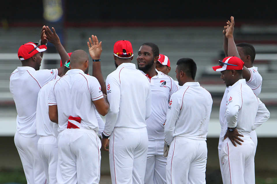 Roshon Primus celebrates with team-mates after taking a wicket