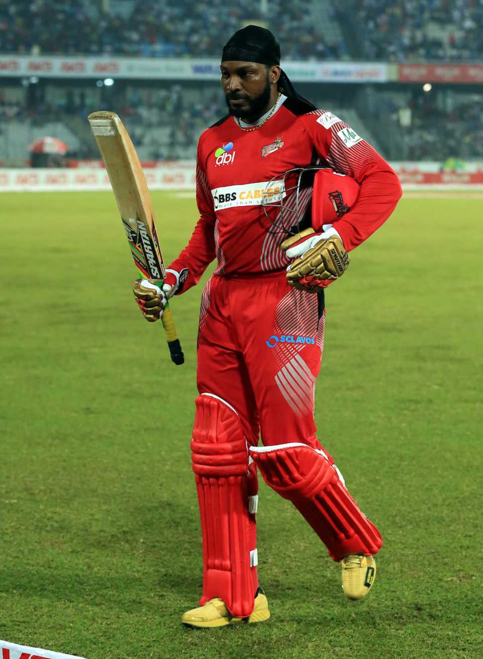 Chris Gayle walks back after clubbing four sixes
