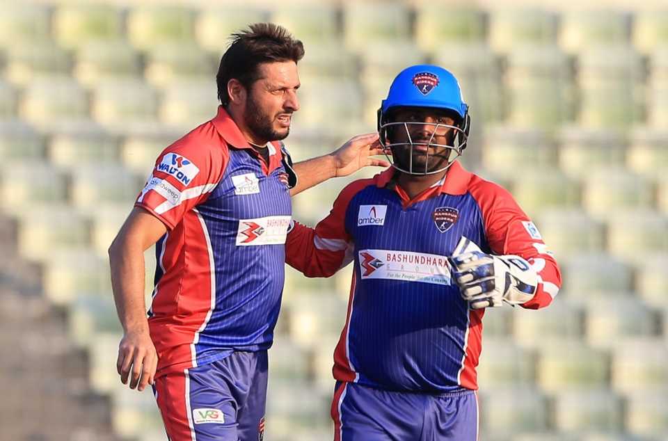 Shahid Afridi celebrates the first of his two wickets with Mohammad Shahzad