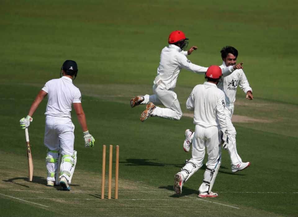 Rashid Khan celebrates with his team-mates after bowling Joe Clarke