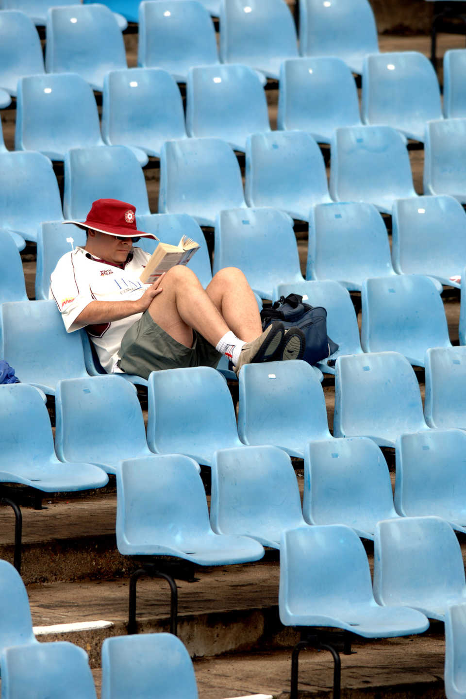 A fan reads in the stands, Northamptonshire v Leicestshire, day one, County Championship Division Two, Northampton, June 15, 2007
