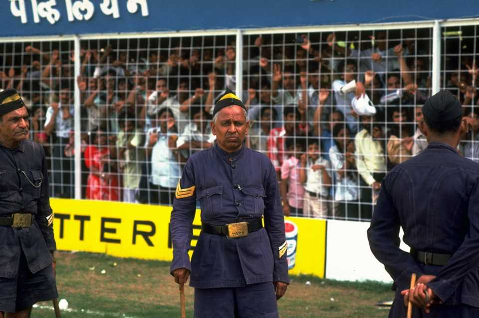 Police stand guard in front of a stand in the Wankhede Stadium