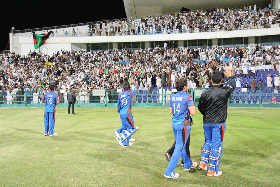 Afghanistan players salute their fans after the win