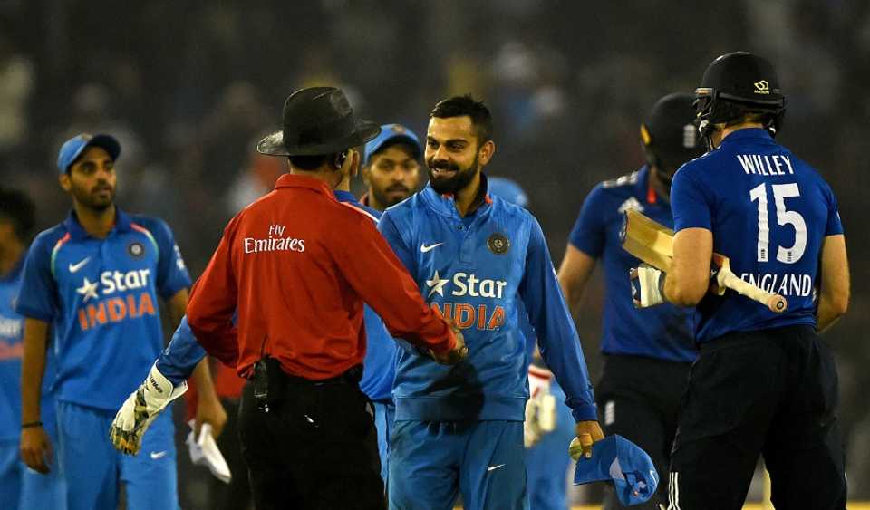Virat Kohli is congratulated by the umpire after India sealed the match