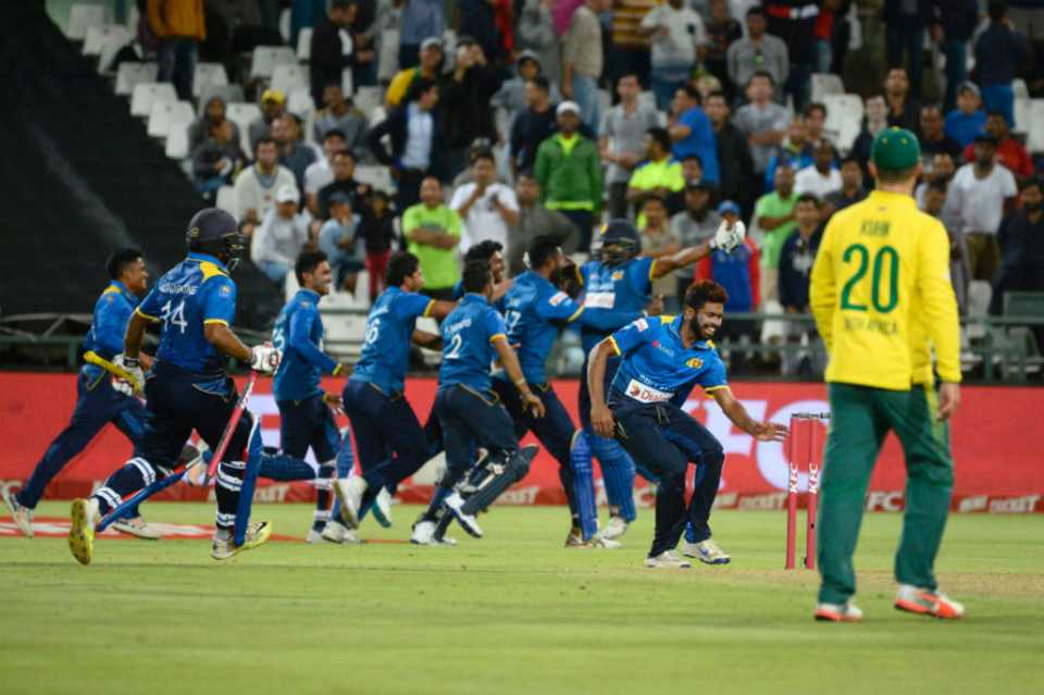 Sri Lanka's players storm the field after sealing a 2-1 series win