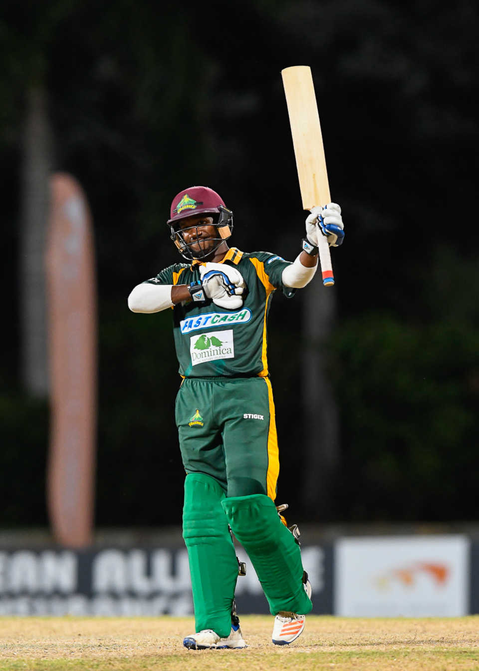Kavem Hodge raises his bat after reaching his maiden List A fifty