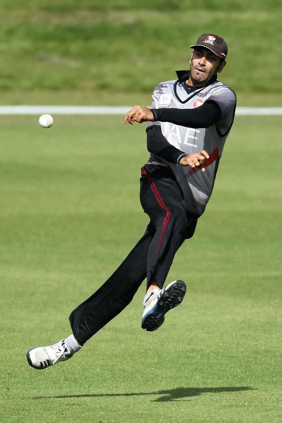 Ahmed Raza throws the ball while fielding