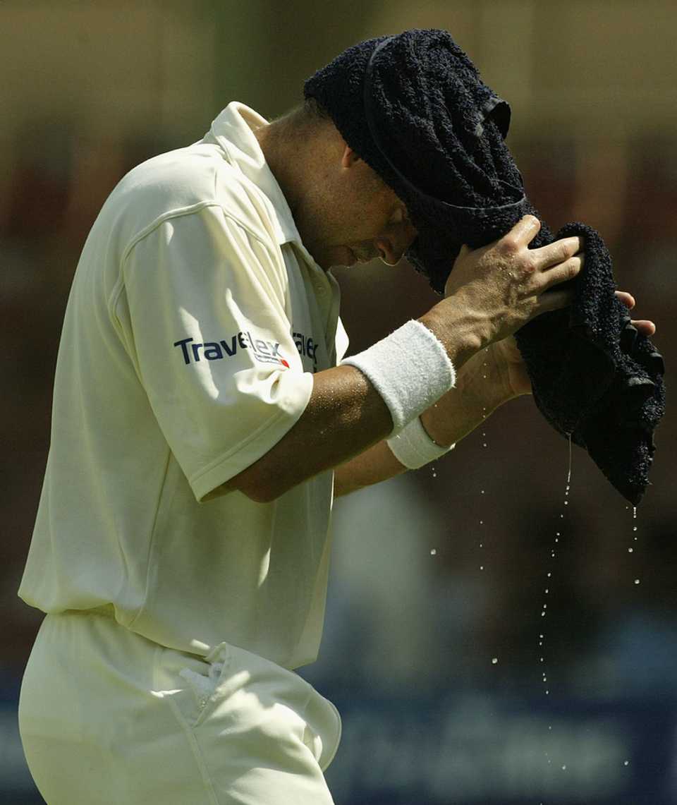 Matthew Hayden of Australia wraps a wet towel around his head to combat the heat during a drinks break, Pakistan v Australia, 3rd Test, Sharjah, 1st day, October 19, 2002