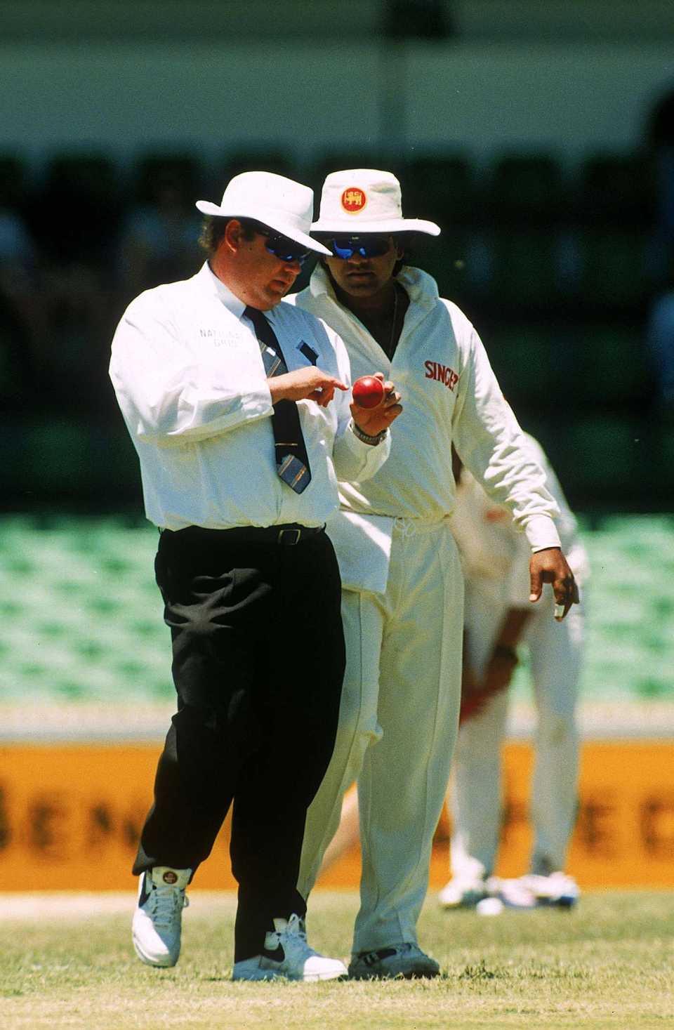 Umpire Peter Parker and Arjuna Ranatunga discuss the state of the ball
