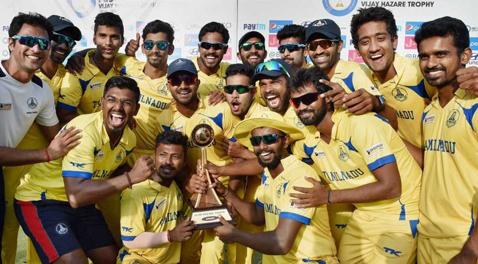 The Tamil Nadu players pose with the Vijay Hazare Trophy after their win