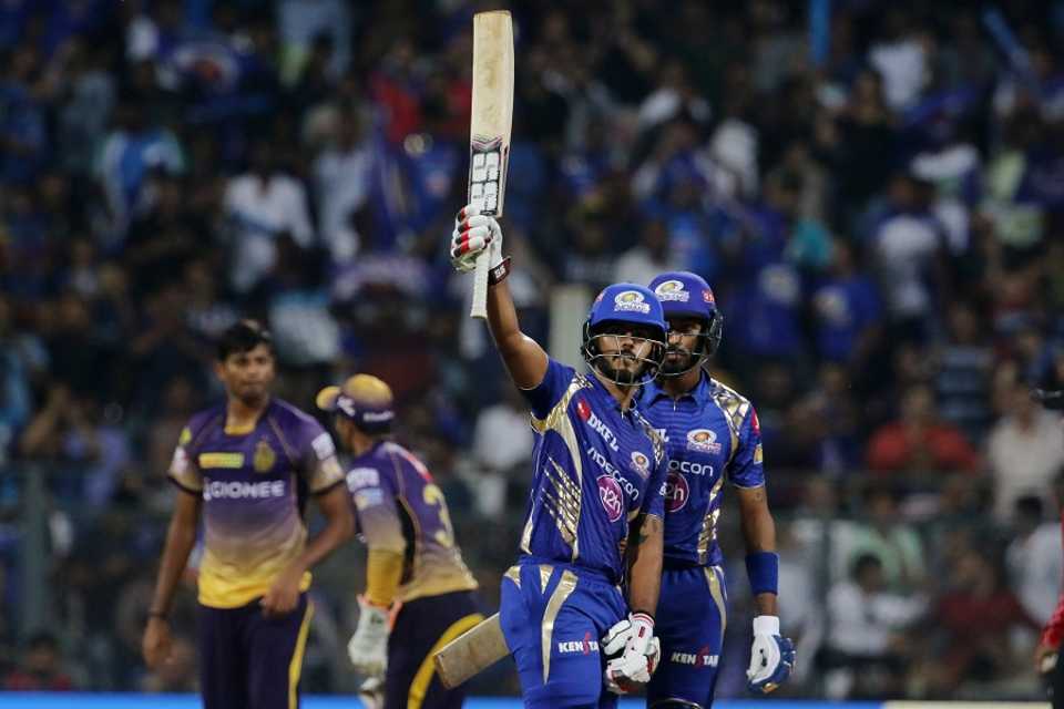 Nitish Rana raises his bat after reaching his fifty