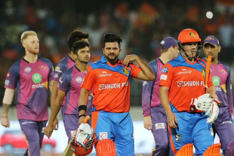 Suresh Raina and Aaron Finch walk back after competing a win for Gujarat Lions