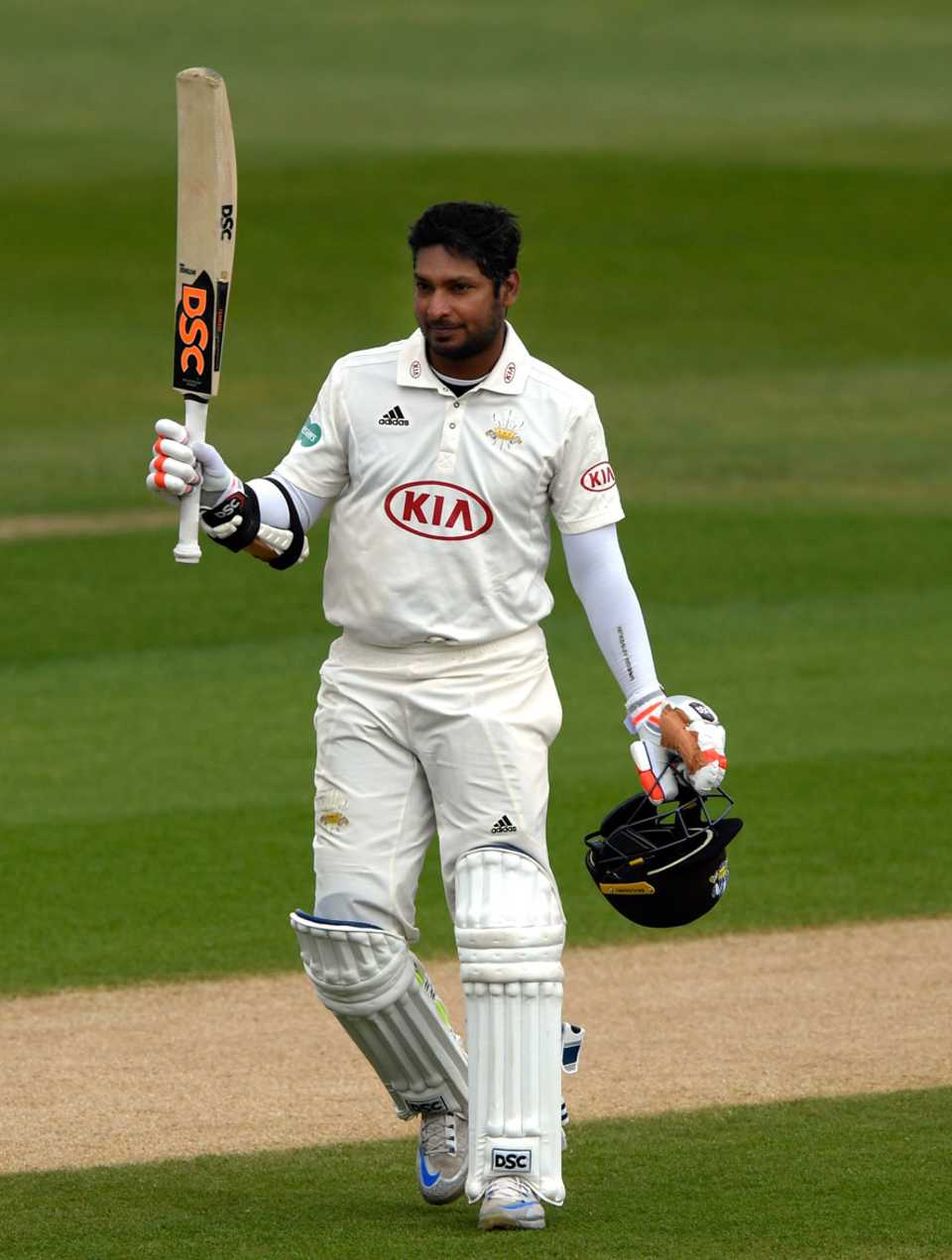 Kumar Sangakkara raises his bat on reaching his ton