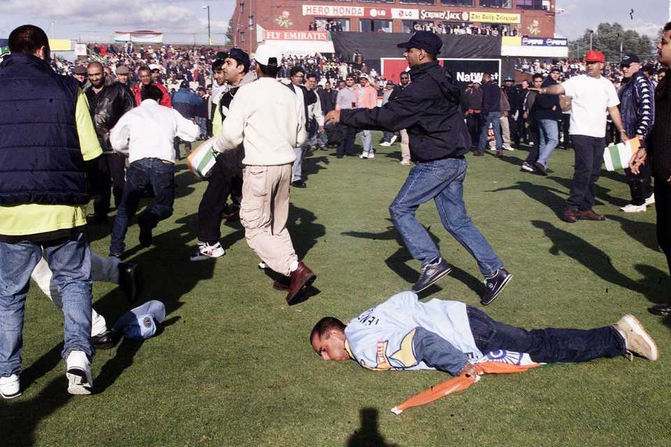 An India fan goes down during a pitch invasion at the end of the World Cup match between India and Pakistan, India v Pakistan, World Cup, 4th Super Six match, Old Trafford, June 8, 1999