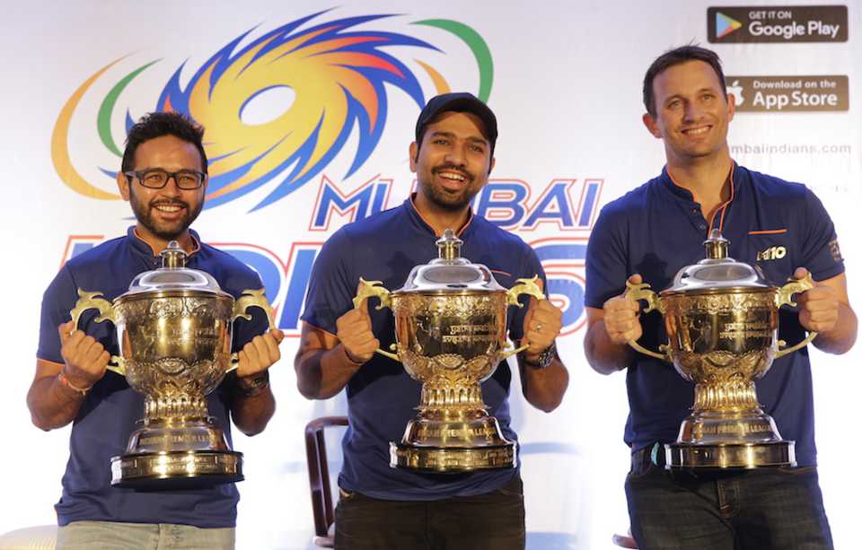 Parthiv Patel, Rohit Sharma and Shane Bond pose with the three IPL trophies