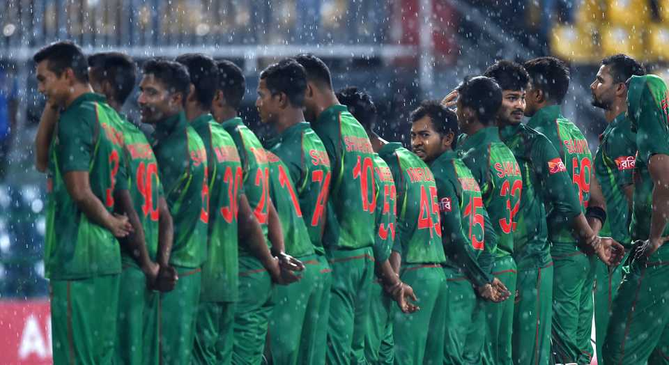 Bangladesh players stand for the anthems in the rain
