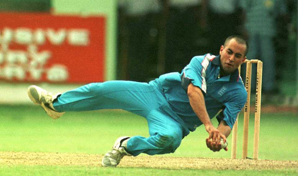 Adam Hollioake takes a catch off his own bowling to dismiss Curtly Ambrose