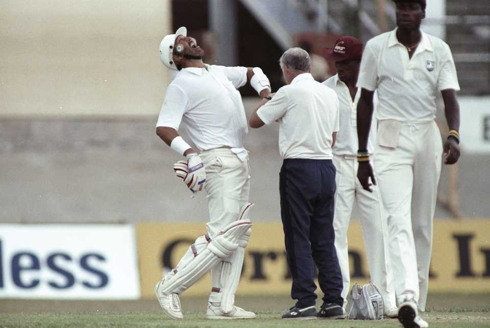 Graham Gooch winces in pain after fast bowler Ezra Moseley bowled a ball that crashed into his fingers and broke a bone