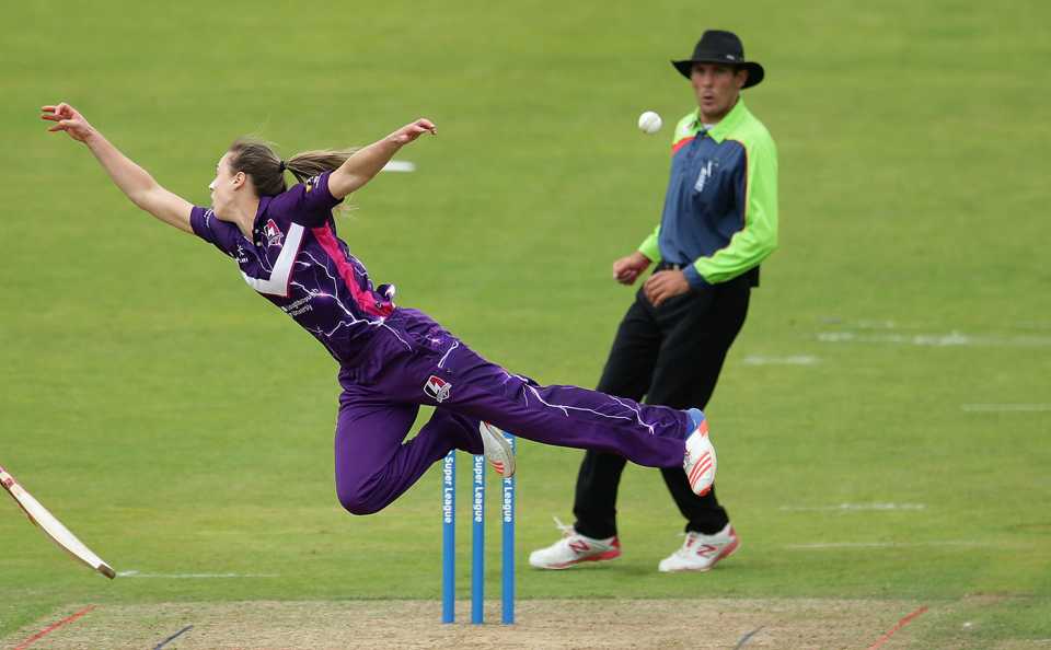 Ellyse Perry leaps to her right in vain to stop the ball