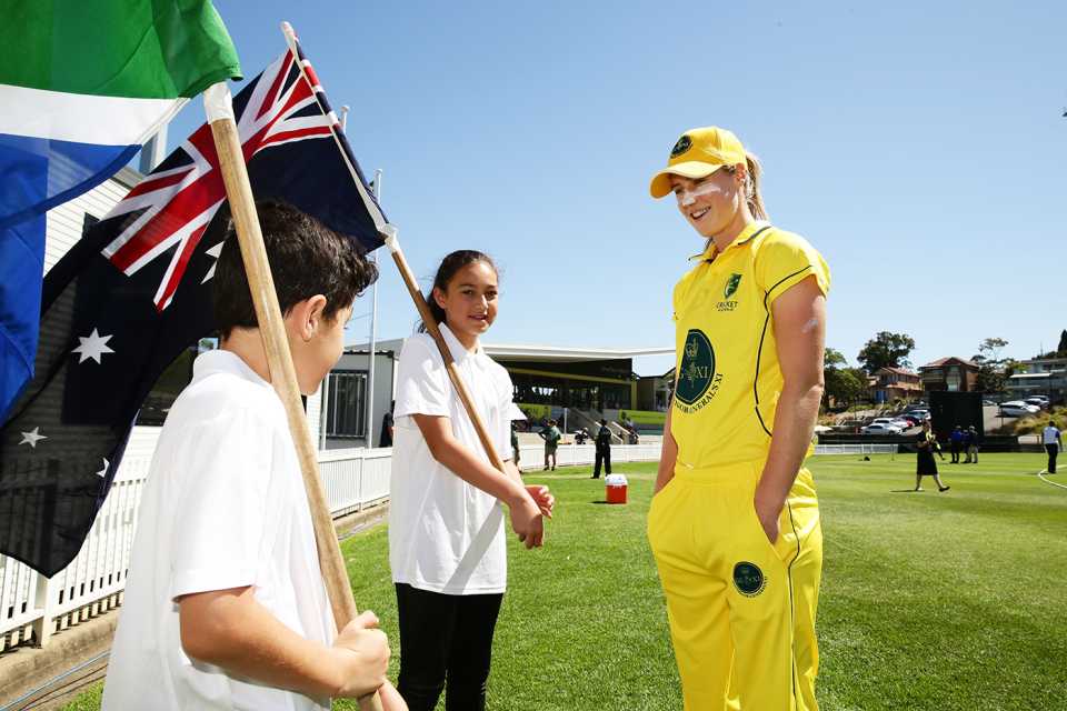 Ellyse Perry talks to two kids before the start of the match