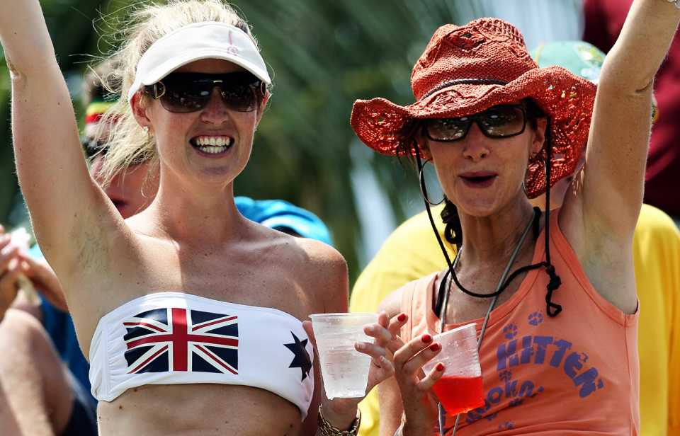 A fan wears a bikini top with the Australian colours on it