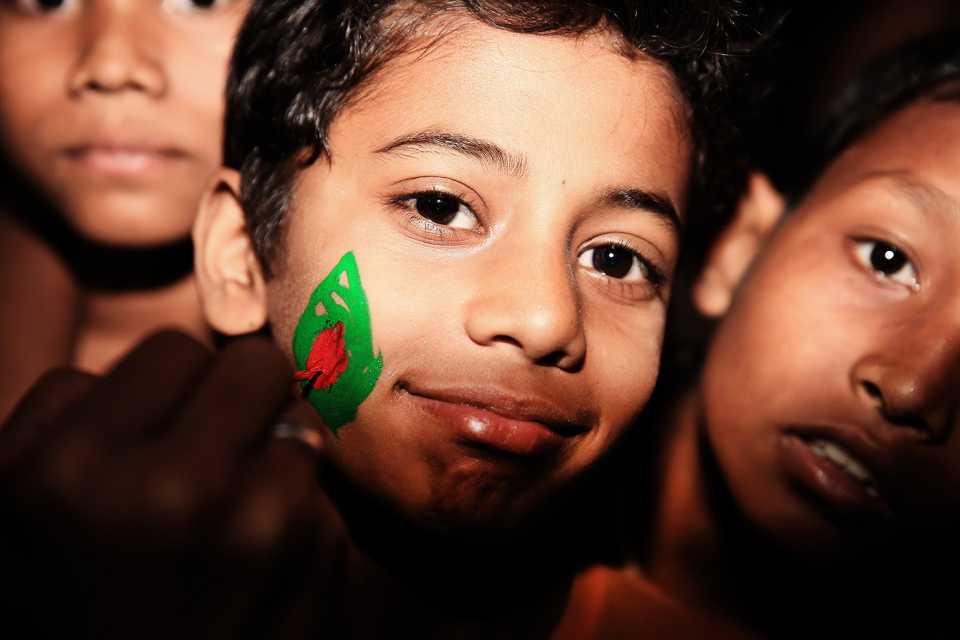 A young fan gets the Bangladesh flag painted on his face