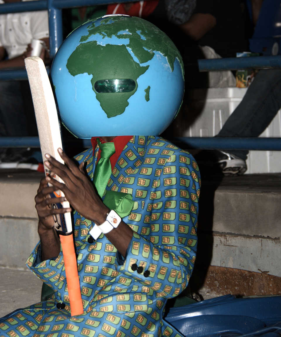 A fan wears a globe on his head at the CPL game 