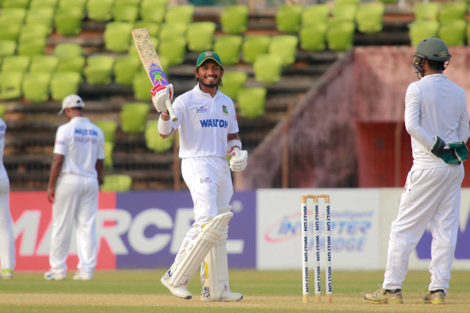 Anamul Haque raises his bat after getting to his century