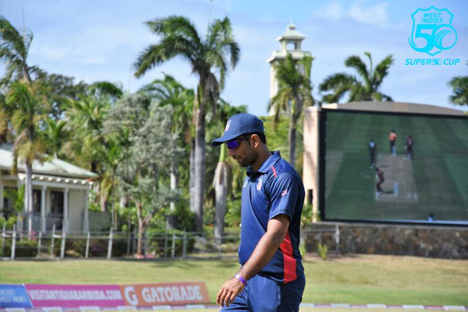 Saurabh Netravalkar walks back to his fielding position