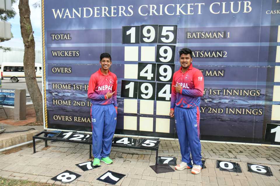 Sandeep Lamichhane and Karan KC pose with the Wanderers scoreboard after their miracle stand, Canada v Nepal, ICC World Cricket League Division Two, Windhoek, February 14, 2018