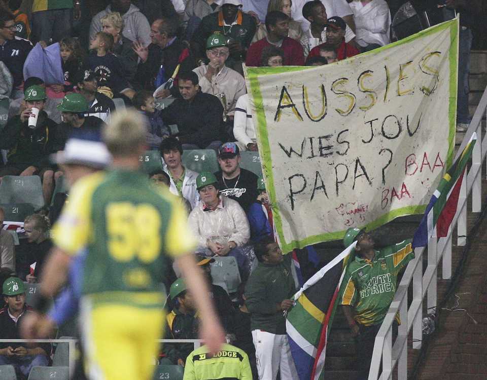South African fans hold up a sign as Brett Lee walks back to his mark