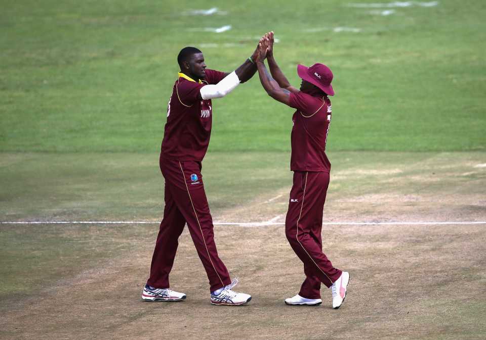 Jason Holder and Marlon Samuels get together to celebrate a wicket, West Indies v Afghanistan, World Cup Qualifiers, Super Six stage, March 15, 2018