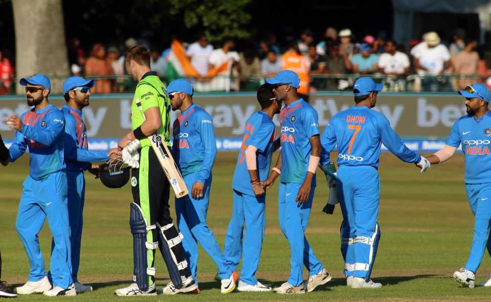 The Indian and Ireland teams shake hands after the match