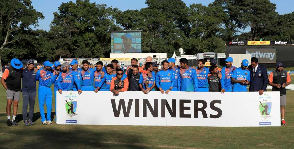 The Indian team prepares to pose with the trophy after winning the series 2-0