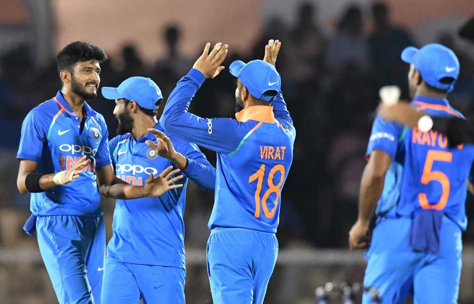 Virat Kohli and Khaleel Ahmed celebrate a wicket with teammates