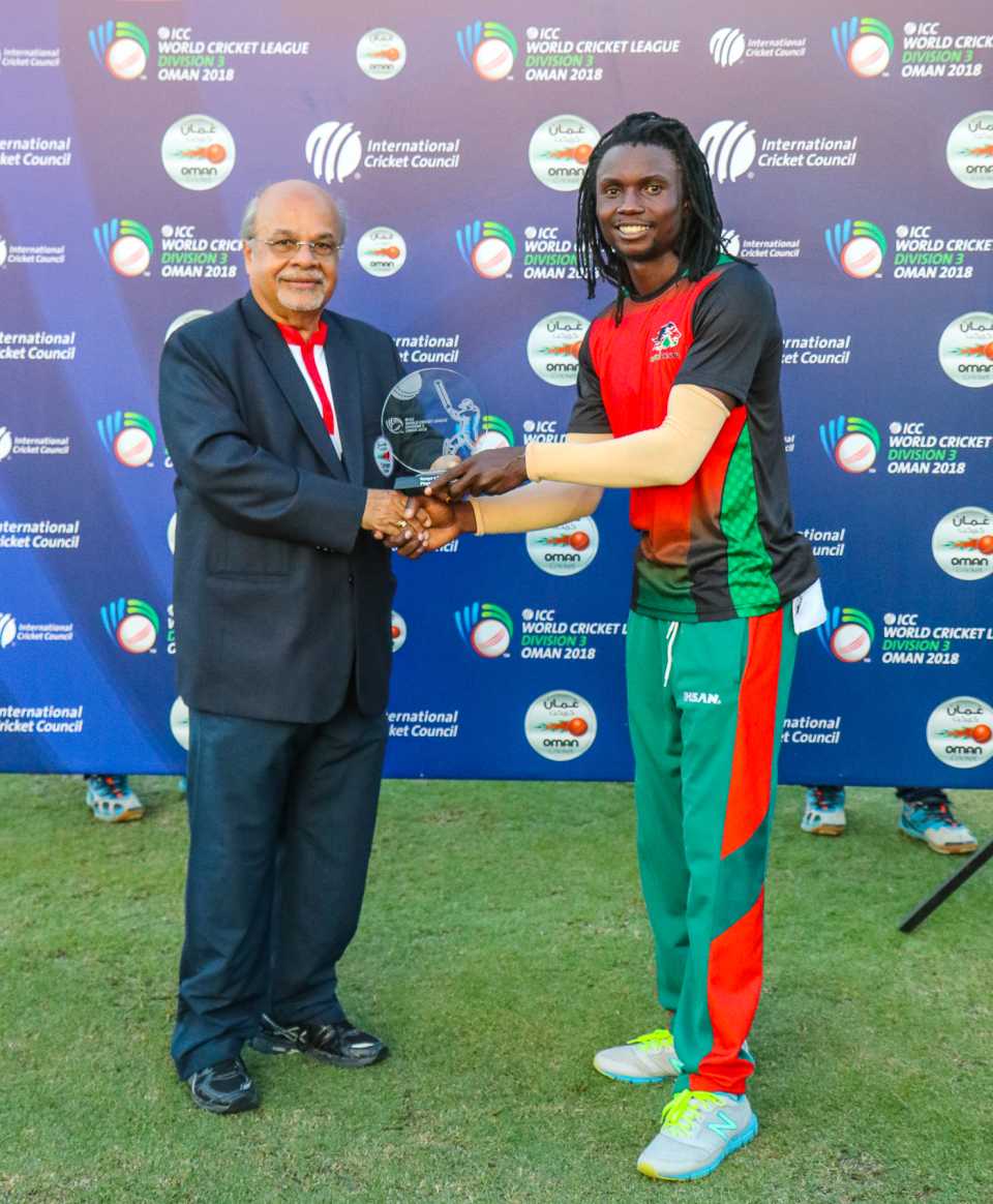 Nelson Odhiambo receives the Man of the Match award for his 80 off 58 balls