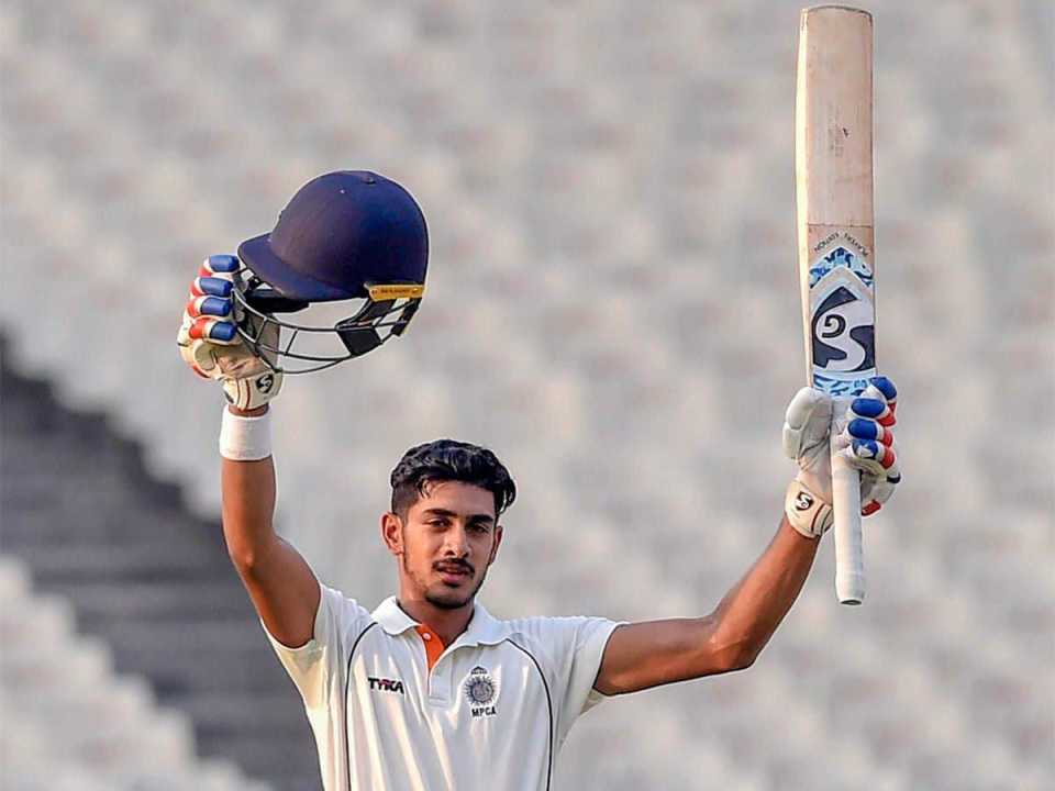 Aryaman Birla raises his bat after his maiden century