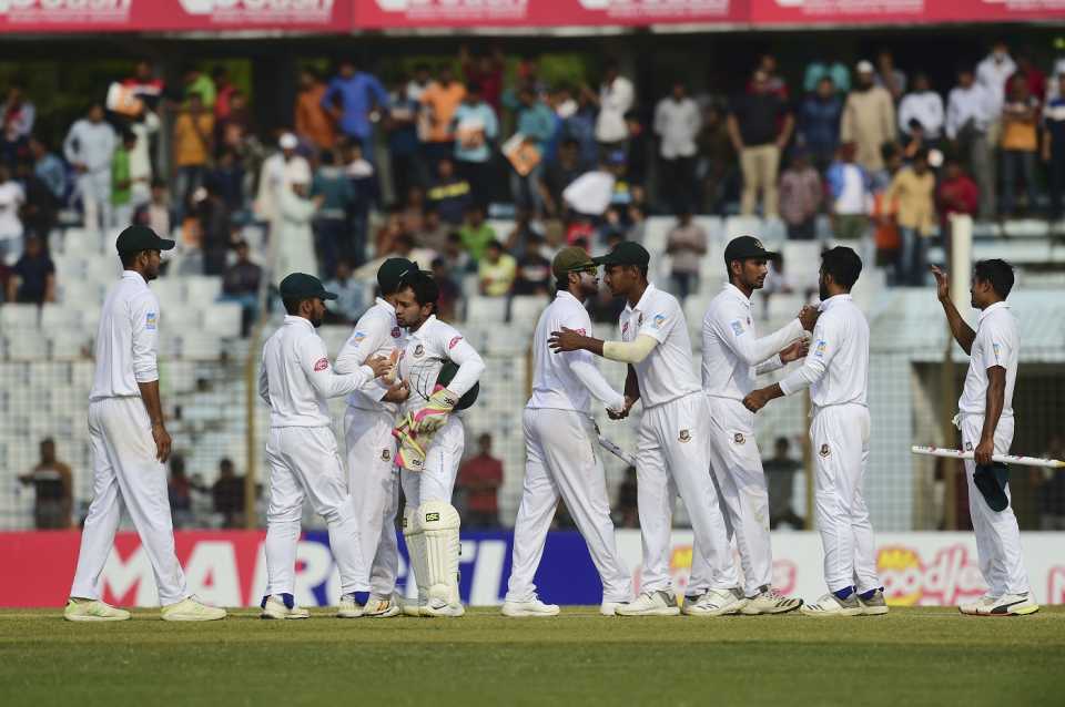 The Bangladesh players congratulate each other after winning the first Test