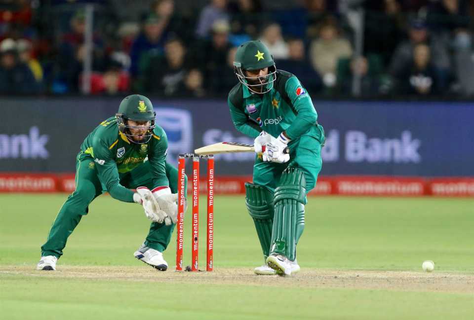 Mohammad Hafeez watches closely as he gets onto the front foot