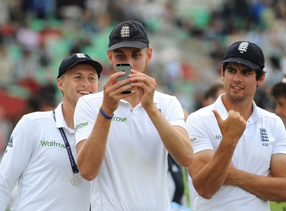 Stuart Broad takes a picture on his phone, Joe Root and Alastair Cook look on, India v England, Fifth Test, Kia Oval, London, 17 August, 2014