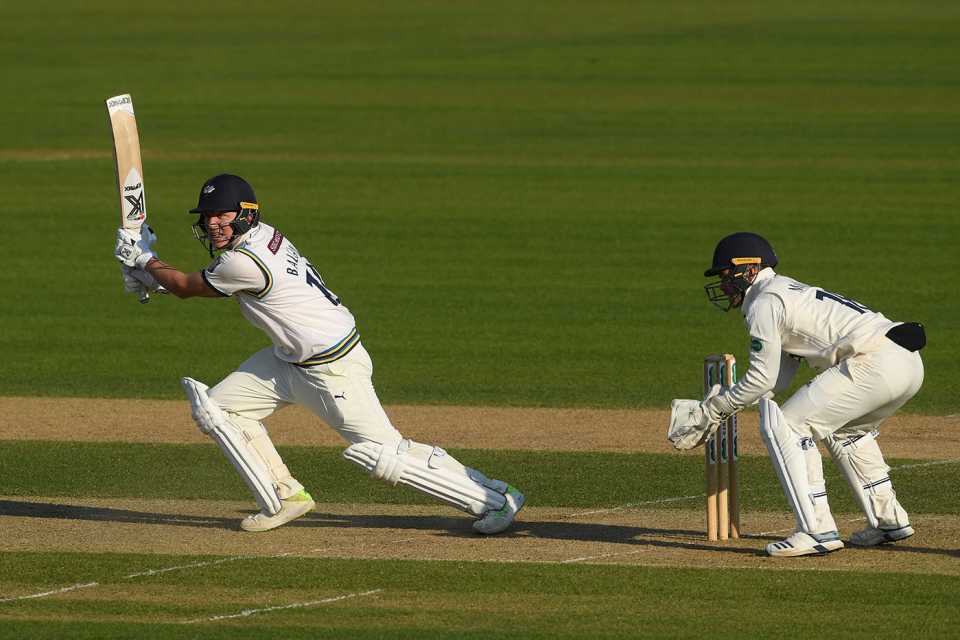 Gary Ballance of Yorkshire hits out as wicketkeeper Lewis McManus of Hampshire looks on