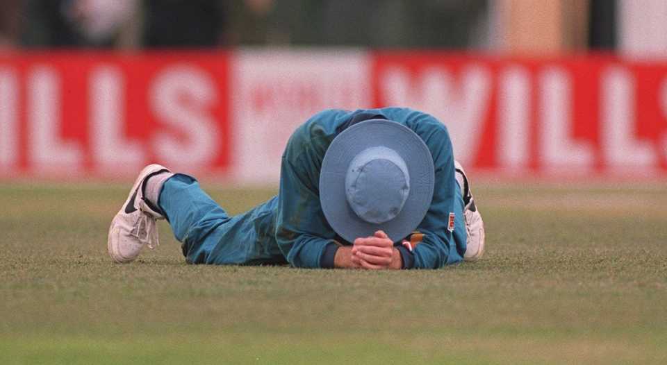 Dominic Cork holds his head after misfielding