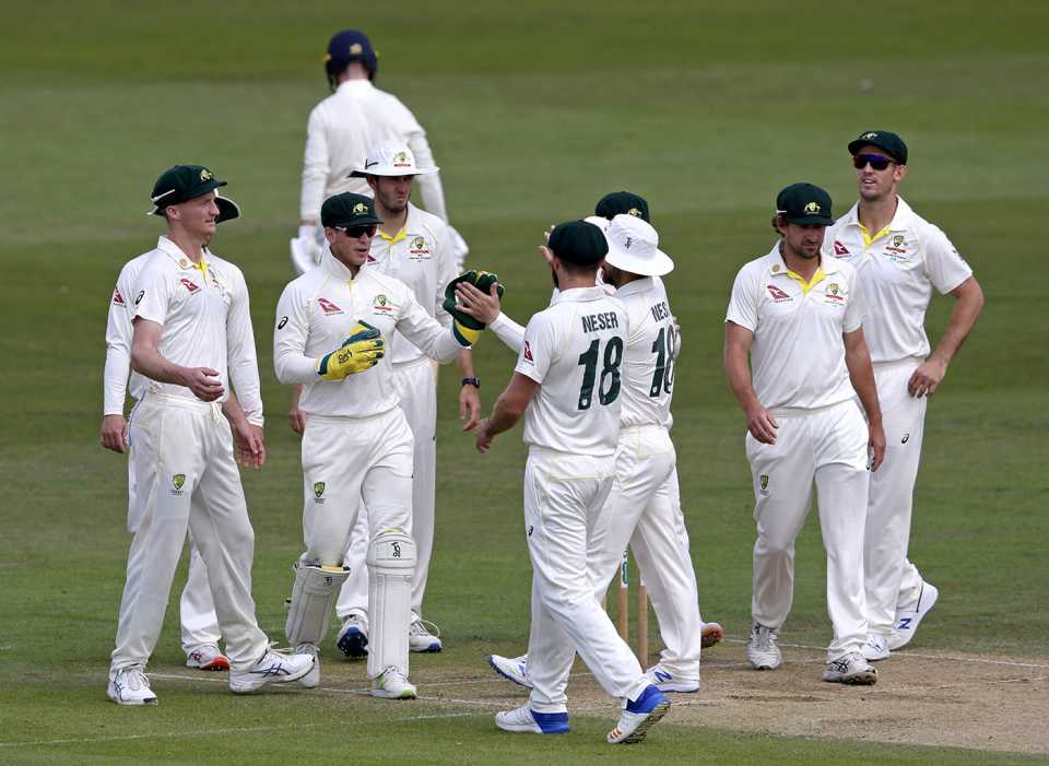 Tim Paine celebrates with team-mates after catching out Jack Leach