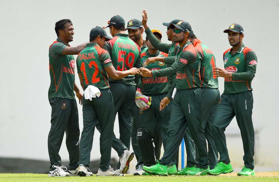 Rubel Hossain is mobbed by his team-mates