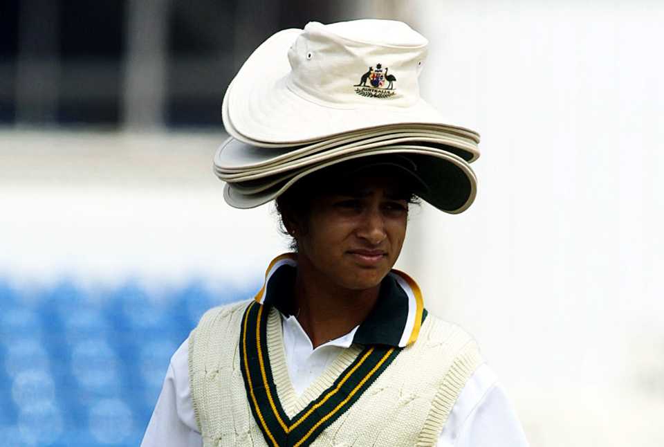 Lisa Sthalekar carries hats and drinks for her team-mates
