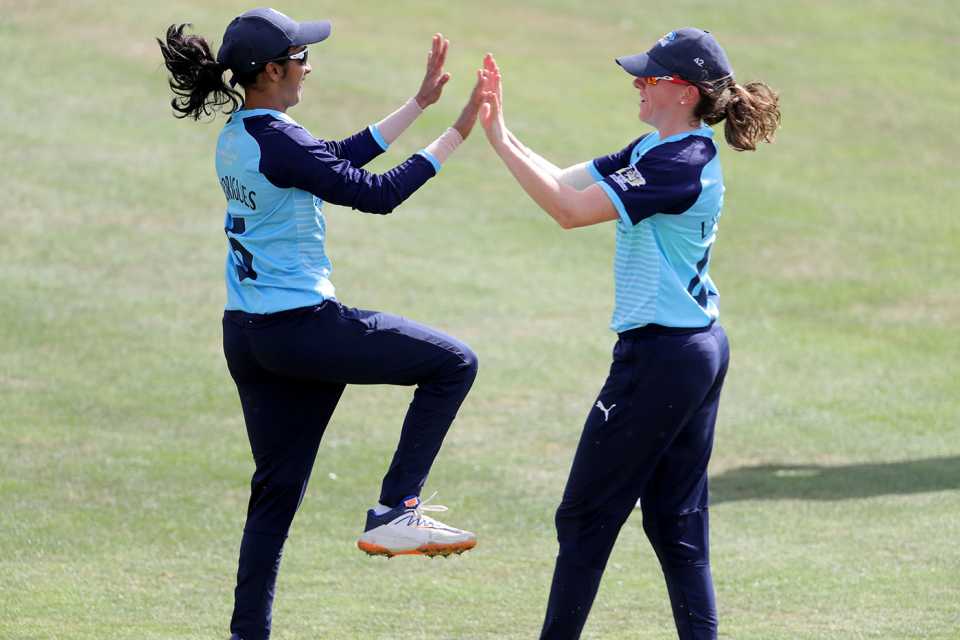 Jemimah Rodrigues and Beth Langston celebrate a dismissal