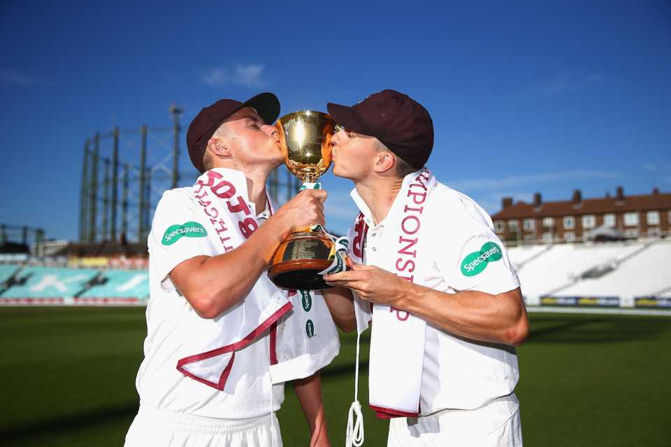 Sam and Tom Curran of Surrey kiss the County Championship Division One Cup