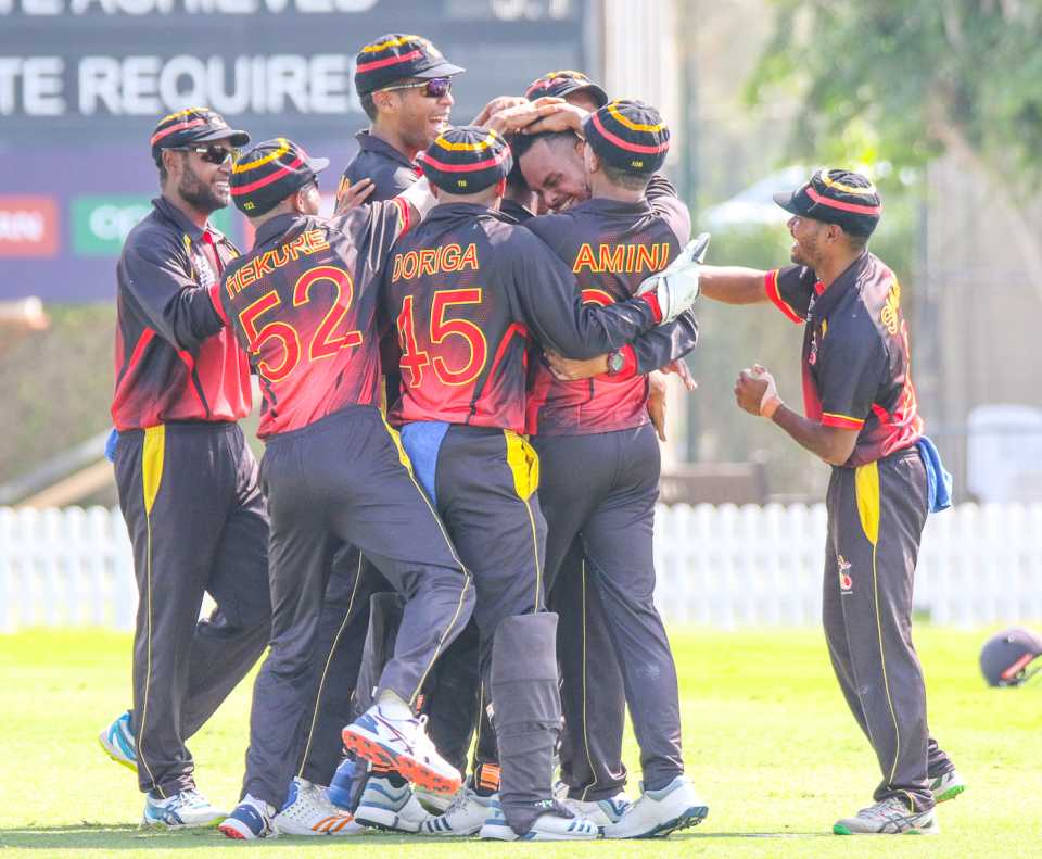 Norman Vanua is mobbed after taking a hat-trick against Bermuda in PNG's opening match, Bermuda v Papua New Guinea, T20 World Cup Qualifier, Dubai, October 19, 2019