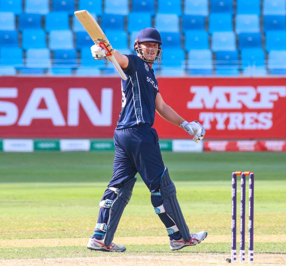 George Munsey raises his bat to the Scotland dugout after reaching a half-century, UAE v Scotland, ICC Men's T20 World Cup Qualifier playoff, Dubai, October 30, 2019